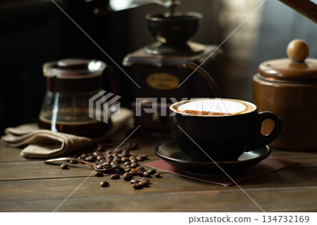 Hot cappuchino in the ceramic cup covered by the foam of milk and cinnamon on top Hot cappuchino in the ceramic cup covered by the foam of milk and cinnamon on top 134732169