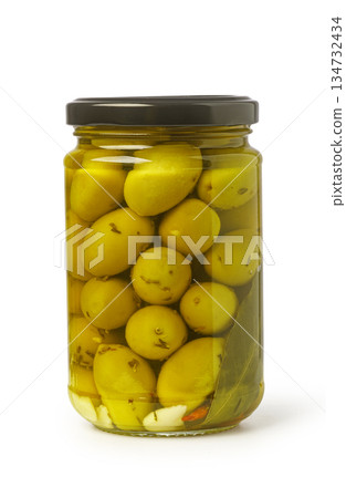 Green pickled olives in jar with herbs 134732434