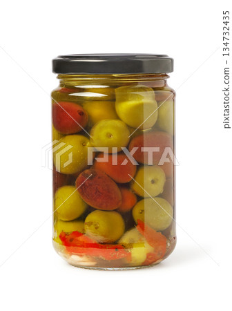 Glass jar filled with colorful pickled olives and spices 134732435