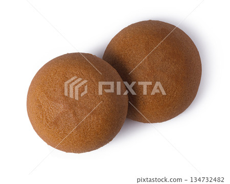 Two round brown snack cakes on white background 134732482