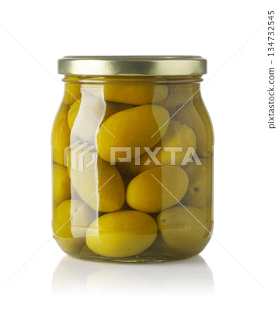 Green olives in glass jar with gold lid Green olives in glass jar with gold lid 134732545