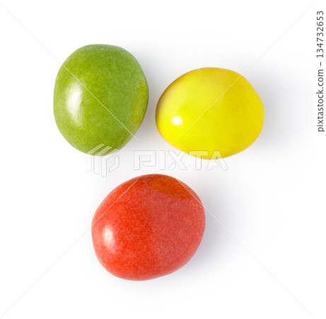Three colorful candy coated chocolates on white background 134732653