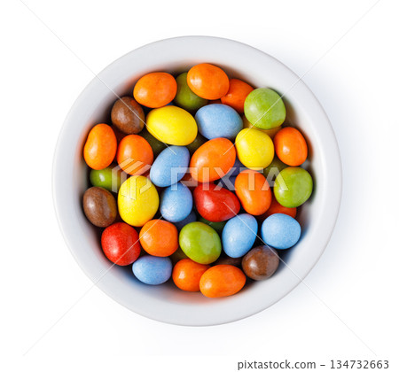 Colorful sugar coated candies in white bowl Colorful sugar coated candies in white bowl 134732663