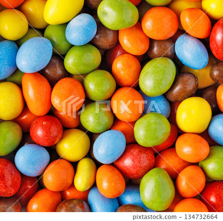 Vibrant candy coated chocolates forming a colorful background Vibrant candy coated chocolates forming a colorful background 134732664