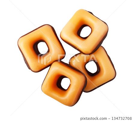 Stacked caramel candy squares with chocolate backing 134732708