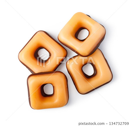 Caramel chocolate candies with square shape and hole Caramel chocolate candies with square shape and hole 134732709