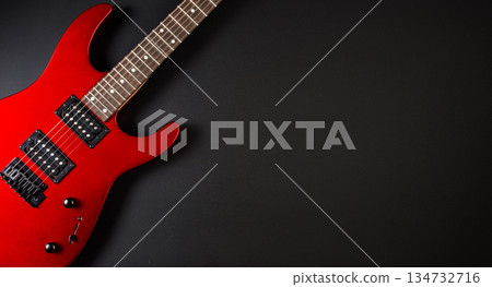 Red electric guitar resting on black background with copy space Red electric guitar resting on black background with copy space 134732716