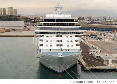 Front view of large cruise ship docked at port terminal 134732827