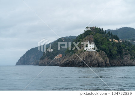 Lighthouse Portofino on Rocky Cliff Above the Mediterranean Sea, Liguria Lighthouse Portofino on Rocky Cliff Above the Mediterranean Sea, Liguria 134732829