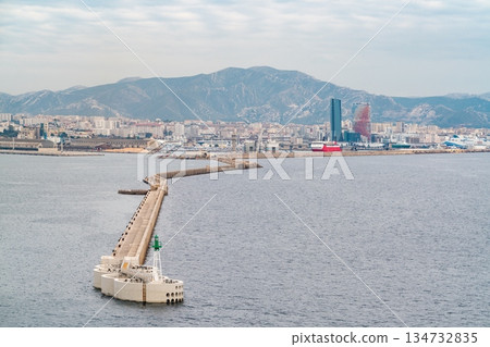 Port of Marseille. Long breakwater leading to the with green beacon, Marseille, France Port of Marseille. Long breakwater leading to the with green beacon, Marseille, France 134732835