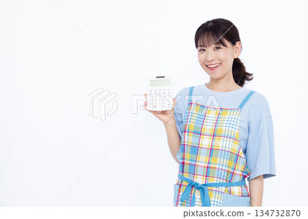 一位微笑的家庭主婦拿著計算器 134732870