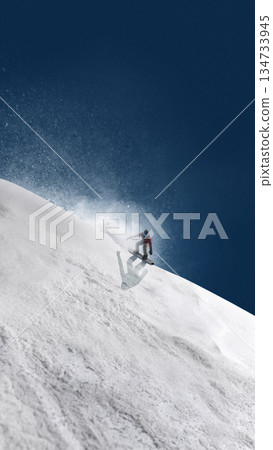 Minimalist design snowboarder jumping above steep snowy ridge. 134733945