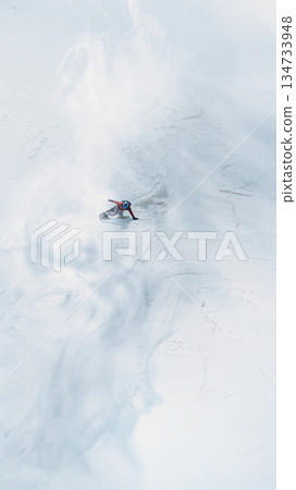 Dynamic artwork aerial snowboarder carving fresh powder on steep alpine slope. 134733948