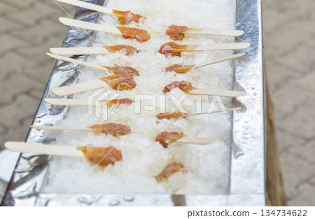Hot maple syrup on a stick in the snow Hot maple syrup on a stick in the snow 134734622
