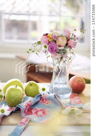 Rose arrangement and apples on the windowsill 134735066