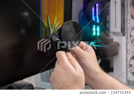Technician examines cracked computer monitor display using magnifying glass, representing professional electronics repair, hardware failure, and technical diagnostic service Technician examines cracked computer monitor display using magnifying glass, representing professional electronics repair, hardware failure, and technical diagnostic service 134735343