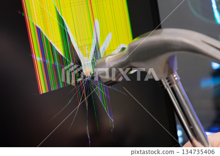 Metal hammer forcefully impacts a monitor screen, causing extensive cracks and vivid, colorful pixel lines, symbolizing technology frustration, damage, or system failure Metal hammer forcefully impacts a monitor screen, causing extensive cracks and vivid, colorful pixel lines, symbolizing technology frustration, damage, or system failure 134735406