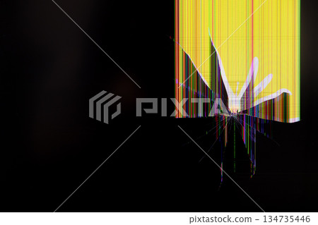 Cracked LCD screen with radial damage and vibrant vertical color lines on a yellow and black background, symbolizing technology malfunction and data error 134735446