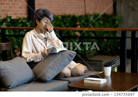 Elderly woman is squeezing relax her eyes to relieve stress and fatigue 134735697