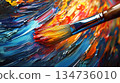 Close-up of paintbrush with vibrant yellow, red, and blue paint strokes 134736010