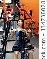 Young woman's fitness exercise with dumbbells gym equipment in the gym promotes a healthy lifestyle 134736028