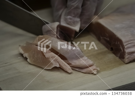 Cut the chicken thighs Cut the chicken thighs 134736038