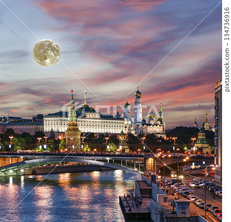 Night view of the Moskva River and Kremlin, Russia, Moscow (most popular view). Against the background of a beautiful sky with clouds, with the moon Night view of the Moskva River and Kremlin, Russia, Moscow (most popular view). Against the background of a beautiful sky with clouds, with the moon 134736916