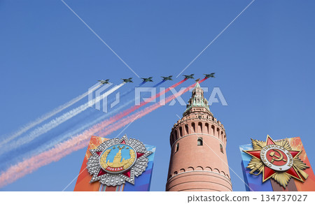 Moscow Kremlin (with decorations of Victory Day celebration (WWII), and Russian military aircraft with painted russian flag, Russia. TRANSLATION: USSR, Victory!, Patriotic war, May 9 Moscow Kremlin (with decorations of Victory Day celebration (WWII), and Russian military aircraft with painted russian flag, Russia. TRANSLATION: USSR, Victory!, Patriotic war, May 9 134737027