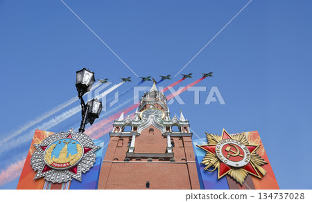Moscow Kremlin (with decorations of Victory Day celebration (WWII), and Russian military aircraft with painted russian flag, Russia. TRANSLATION: USSR, Victory!, Patriotic war, May 9 134737028