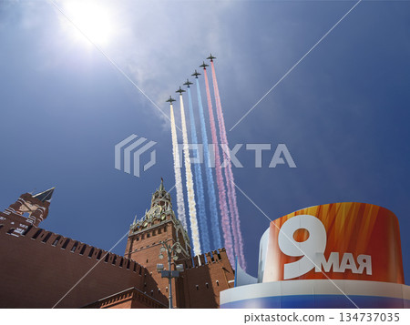 Moscow Kremlin (with decorations of Victory Day celebration (WWII), and Russian military aircraft with painted russian flag, Russia. TRANSLATION: USSR, Victory!, Patriotic war, May 9 134737035