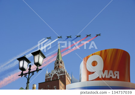 Moscow Kremlin (with decorations of Victory Day celebration (WWII), and Russian military aircraft with painted russian flag, Russia. TRANSLATION: USSR, Victory!, Patriotic war, May 9 Moscow Kremlin (with decorations of Victory Day celebration (WWII), and Russian military aircraft with painted russian flag, Russia. TRANSLATION: USSR, Victory!, Patriotic war, May 9 134737039