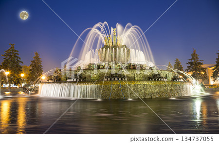 Fountain Stone Flower (at night with the super moon) at VDNKh in Moscow. VDNKh (called also All-Russian Exhibition Center) is a permanent general-purpose trade show in Moscow, Russia Fountain Stone Flower (at night with the super moon) at VDNKh in Moscow. VDNKh (called also All-Russian Exhibition Center) is a permanent general-purpose trade show in Moscow, Russia 134737055