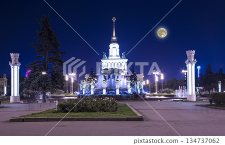 Landmarks in the territory of VDNKh (All-Russia Exhibition Centre, also called All-Russian Exhibition Center) with the super moon --  is a permanent general-purpose trade show in Moscow, Russia 134737062