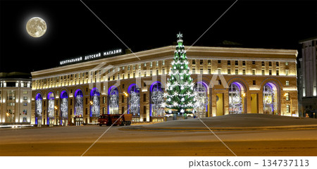 Christmas (New Year holidays) illumination of the Central Children's Store on Lubyanka (inscription in Russian) at night, with the super moon, Moscow, Russia 134737113
