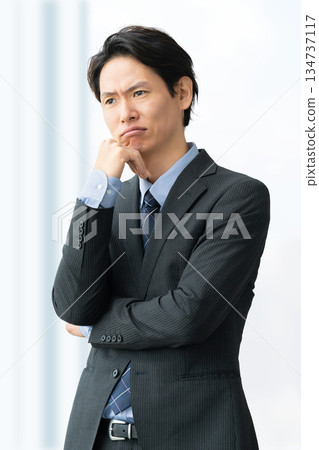 A male businessman thinking A male businessman thinking 134737117