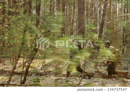 American Soldiers Of USA Infantry Of World War II Marching Running Run Along Forest In Autumn Spring Day. Group of soldiers American Soldiers Of USA Infantry Of World War II Marching Running Run Along Forest In Autumn Spring Day. Group of soldiers 134737547