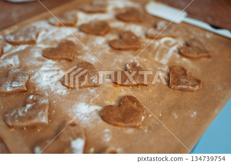 making heart-shaped gingerbread cookies making heart-shaped gingerbread cookies 134739754