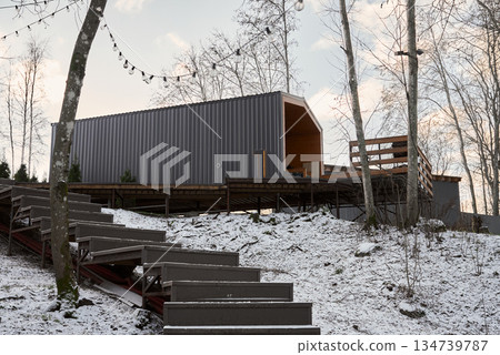 Charming wooden shelter with festive lighting during sunset Charming wooden shelter with festive lighting during sunset 134739787