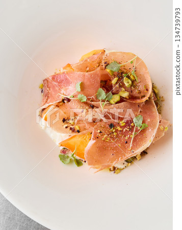 Sophisticated culinary creation featuring Italian ham and herbal accents Sophisticated culinary creation featuring Italian ham and herbal accents 134739793