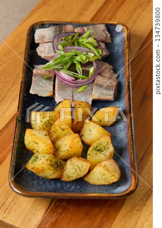 Seared fillet with greens, Elegant serving of grilled fish with vegetables and crispy potatoes 134739800