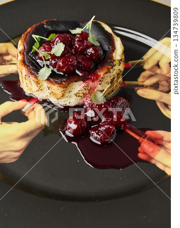 Group of friends enjoying sticky cherry pancakes together Group of friends enjoying sticky cherry pancakes together 134739809