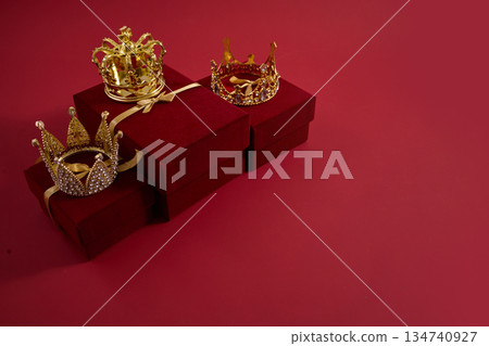 Three golden crowns resting on red gift boxes. Three golden crowns representing Epiphany, three wise day Three golden crowns resting on red gift boxes. Three golden crowns representing Epiphany, three wise day 134740927