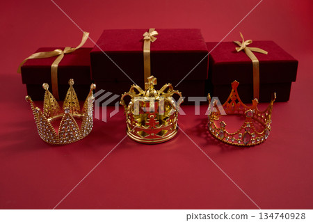 Gold crowns with gift boxes symbolizing luxury and reward. Three golden crowns representing Epiphany, three wise day Gold crowns with gift boxes symbolizing luxury and reward. Three golden crowns representing Epiphany, three wise day 134740928