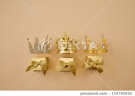 Three golden crowns representing epiphany and three wise on glitter background 134740930