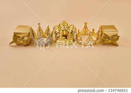 Golden crowns and gift boxes symbolizing royalty and celebration 134740931