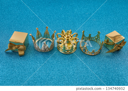 Three golden crowns representing epiphany and three wise on glitter background 134740932