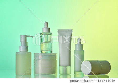 Skincare cosmetic products standing against gradient background Skincare cosmetic products standing against gradient background 134741016