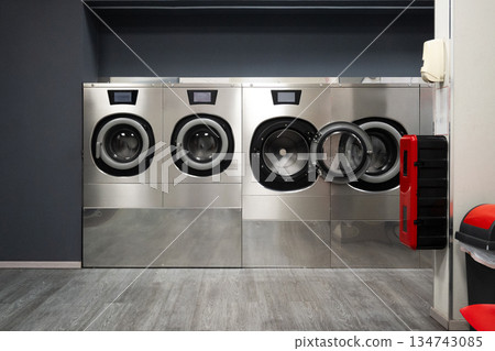 Modern Self-Service Laundromat with Industrial Washing Machines Modern Self-Service Laundromat with Industrial Washing Machines 134743085