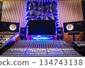 home recording studio. mixing console, studio monitors, desktop computer and professional audio equipment with modern sound diffuser wall design. 134743138
