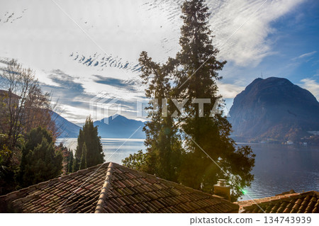 Awe view on red tiled roofs and lake Lugano Awe view on red tiled roofs and lake Lugano 134743939